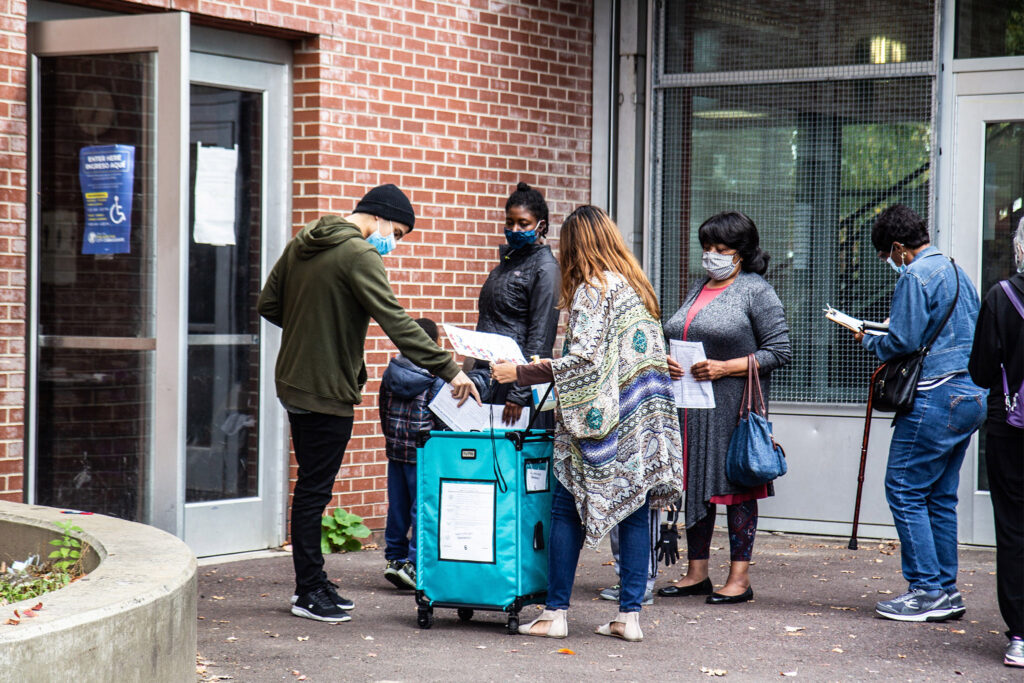 satelliteelectionoffice-2020october-voters-mailballot-01 A voter drops a ballot in the box at the Julia De Burgos satellite election office. (Kimberly Paynter/WHYY)