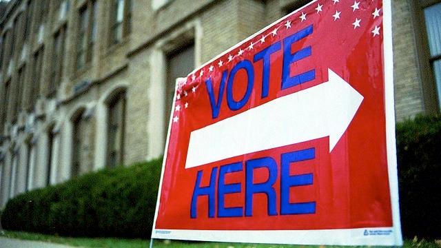 A sign points voters in the direction of a polling place