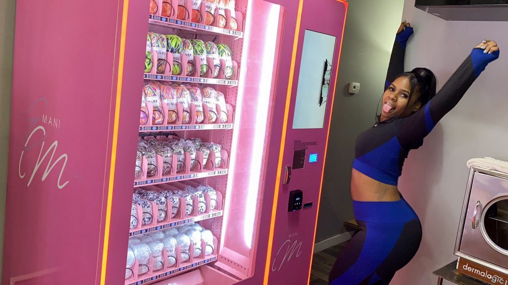 yarnvendingmachine-emani-1024×576 Emani Outterbridge next to her first yarn vending machine in a barbershop at 16th and Cecil B. Moore. (Twitter/@_EmaniMilan)