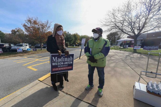 Madinah Wilson-Anton (left), candidate for  Delaware House of Representatives, speaks to a members of the public on election day Tuesday, Nov. 03, 2020, at Thurgood Marshall elementary school in Newark, Del. (Saquan Stimpson for WHYY)