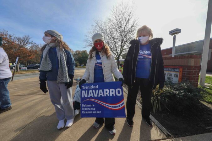 A supporter stands in front of a polling location on election day, Tuesday, Nov. 03, 2020, at Thurgood Marshall elementary school in Newark, Del. (Saquan Stimpson for WHYY)