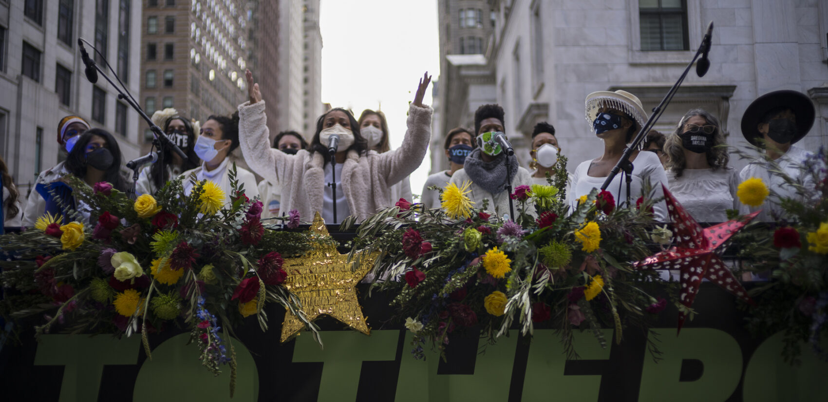 The Resistance Revival Chorus performs in front of City Hall, onboard a flatbed truck, as part of a voter motivational effort called 