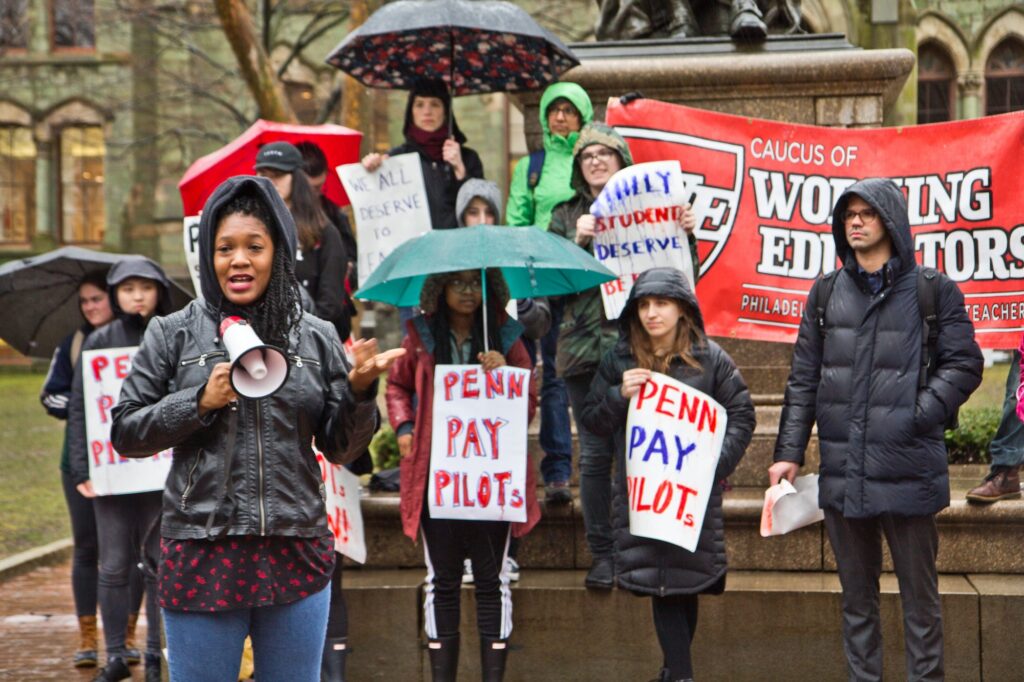 2019-03-21-pilot-rally-4-e1553433020876 Gina Dukes, a Penn alumna and a Philadelphia school district teacher, speaks at a rally to demand UPenn make PILOT payments. (Kimberly Paynter/WHYY)