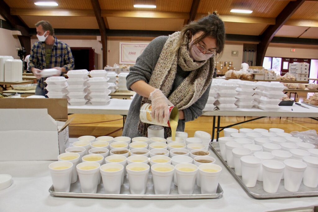 2020 11 25-e lee-jayne clauss-warrington pa saint robert bellarmine church-thanksgiving meals Jayne Clauss pours servings of gravy at St. Robert Bellarmine Church