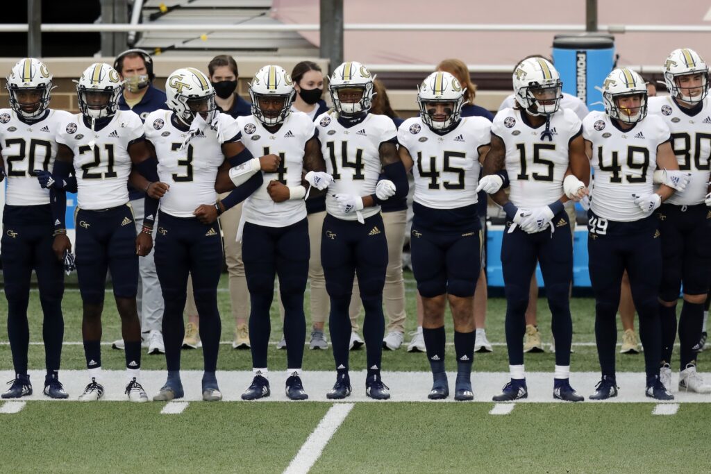 Georgia Tech Boston College Football Georgia Tech players link arms before an NCAA college football game against Boston College as part of the Atlantic Coast Conference's first Unity Week, Saturday, Oct. 24, 2020, in Boston. (AP Photo/Michael Dwyer)