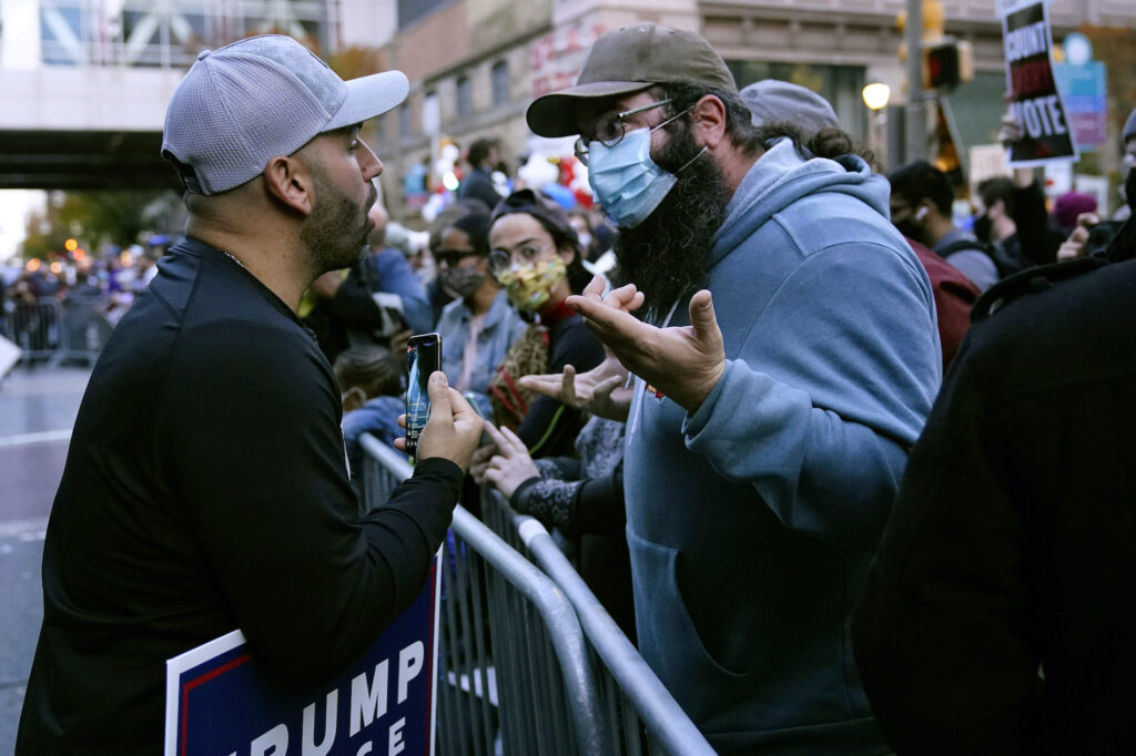 Protesters exchange points of view outside the Pennsylvania Convention Center where votes were being counted, Thursday, Nov. 5, 2020, in Philadelphia, following the Nov. 3 election. (AP Photo/Matt Slocum)
