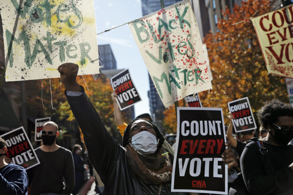 Election 2020 One Nation Under Siege Zhanon Morales, 30, of Philadelphia, raises her fist as demonstrators call for all votes be counted during a rally outside the Pennsylvania Convention Center, Thursday, Nov. 5, 2020, in Philadelphia. (AP Photo/Rebecca Blackwell)