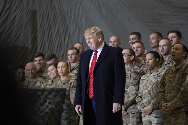 FILE - In this Nov. 28, 2019, file photo President Donald Trump smiles before addressing members of the military during a surprise Thanksgiving Day visit at Bagram Air Field, Afghanistan. (AP Photo/Alex Brandon, File)
