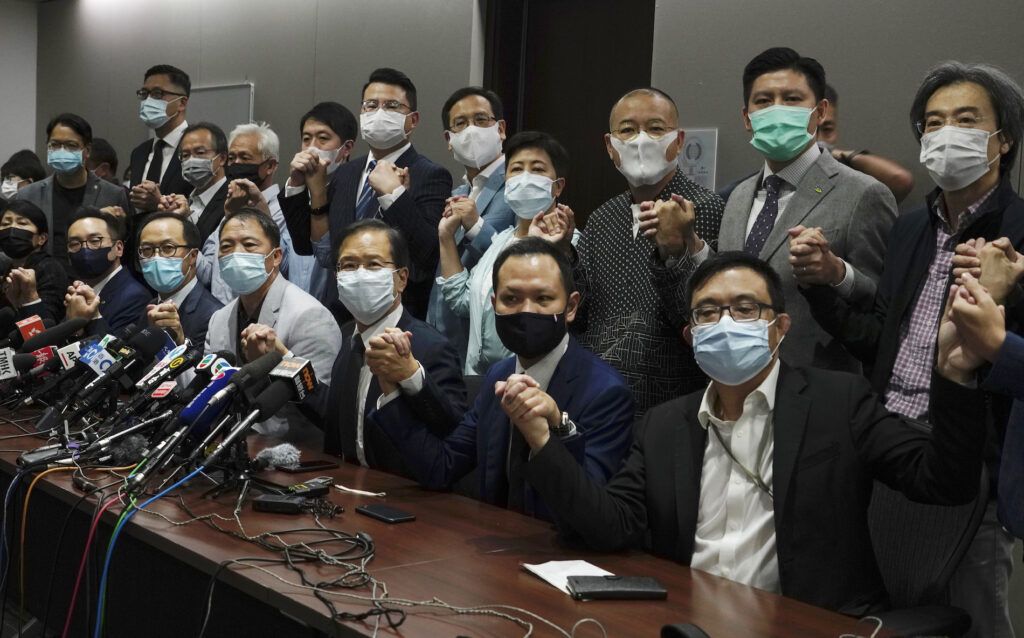 Hong Kong's pro-democracy legislators pose a picture before a press conference at Legislative Council in Hong Kong, Wednesday, Nov. 11, 2020.  Hong Kong’s pro-democracy lawmakers announced that they are resigning en masse following a move by the city’s government to disqualify four pro-democracy legislators. (AP Photo/Vincent Yu)