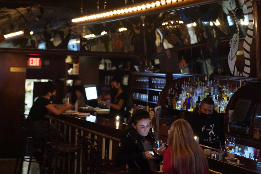 Virus Outbreak New Jersey Patrons enjoy food and drink at The Brass Rail in Hoboken, N.J., Wednesday, Nov. 11, 2020. (AP Photo/Seth Wenig)