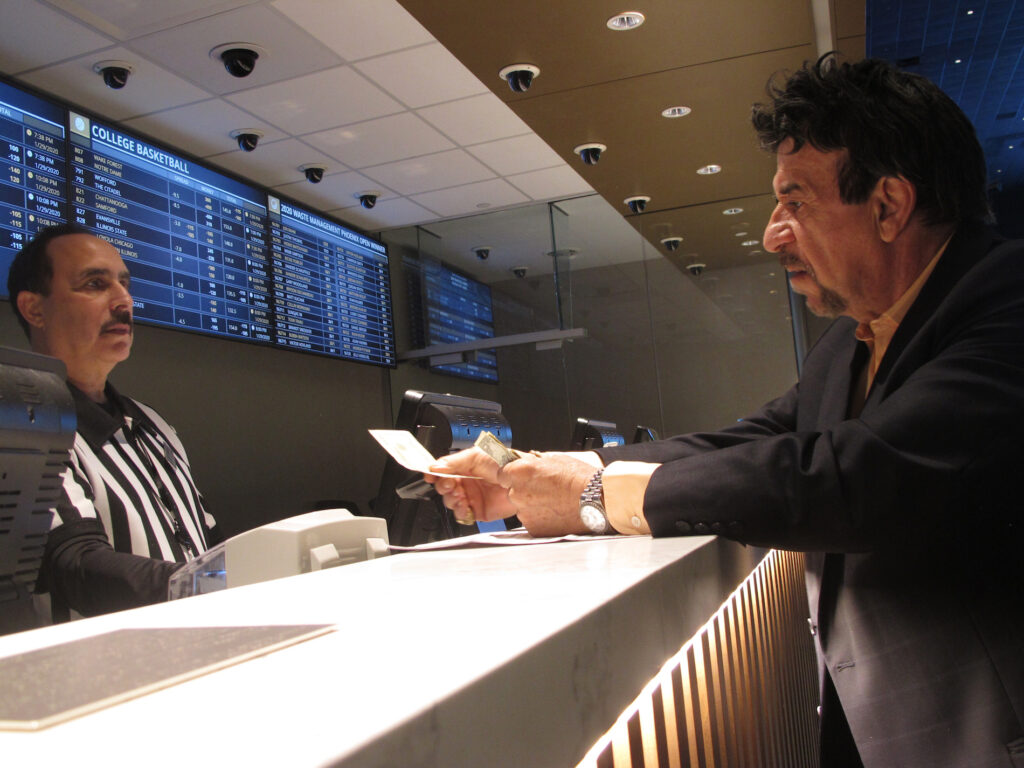 New Jersey Gambling Revenue A gambler makes a sports bet at Bally's casino in Atlantic City, N.J. on Jan. 29, 2020. On Nov. 13, 2020, New Jersey gambling regulators released figures showing that the state's red-hot sports betting market had set a new national record for the most money wagered on sports for the third month in a row, taking in over $803 million worth of bets. (AP Photo/Wayne Parry)