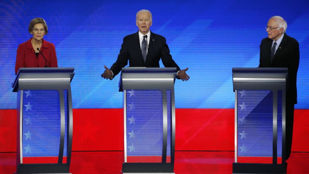Biden Cabinet In this Feb. 7, 2020, file photo Democratic presidential candidate former Vice President Joe Biden, center, speaks as Sen. Elizabeth Warren, D-Mass., left, and Sen. Bernie Sanders, I-Vt., listen during a Democratic presidential primary debate hosted by ABC News, Apple News, and WMUR-TV at Saint Anselm College in Manchester, N.H. (AP Photo/Elise Amendola)