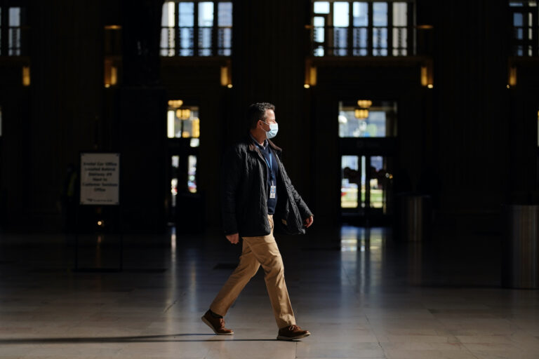 A man walks through the 30th Street Station ahead of the Thanksgiving holiday, Friday, Nov. 20, 2020, in Philadelphia. With the coronavirus surging out of control, the nation's top public health agency pleaded with Americans not to travel for Thanksgiving and not to spend the holiday with people from outside their household. (AP Photo/Matt Slocum)