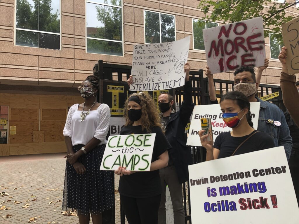 Immigration Detention-Georgia FILE - In this Sept. 15, 2020, file photo, Dawn Wooten, left, a nurse at Irwin County Detention Center in Ocilla, Georgia, speaks at a news conference in Atlanta protesting conditions at the immigration jail. The U.S. government has agreed temporarily not to deport detained immigrant women who have alleged being abused by a rural Georgia gynecologist who was seeing patients at the detention center, according to court papers filed Tuesday, Nov. 24. (AP Photo/Jeff Amy, File)