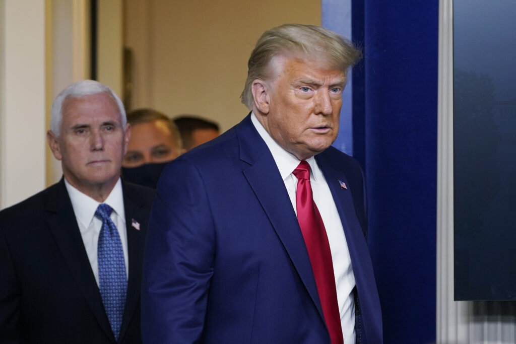 Trump President Donald Trump walks out to speak in the Brady Briefing Room in the White House, Tuesday, Nov. 24, 2020, in Washington, with Vice President Mike Pence. (AP Photo/Susan Walsh)