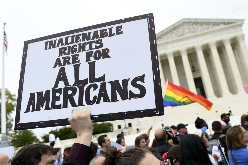 LGBT protesters In this Oct. 8, 2019, file photo, protesters gather outside the Supreme Court in Washington where the Supreme Court is hearing arguments in the first case of LGBT rights since the retirement of Supreme Court Justice Anthony Kennedy. (AP Photo/Susan Walsh)