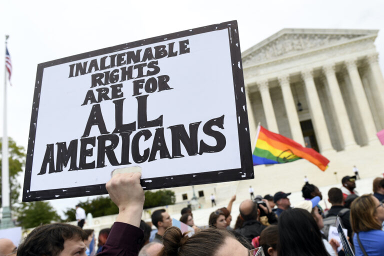 In this Oct. 8, 2019, file photo, protesters gather outside the Supreme Court in Washington where the Supreme Court is hearing arguments in the first case of LGBT rights since the retirement of Supreme Court Justice Anthony Kennedy.  (AP Photo/Susan Walsh)