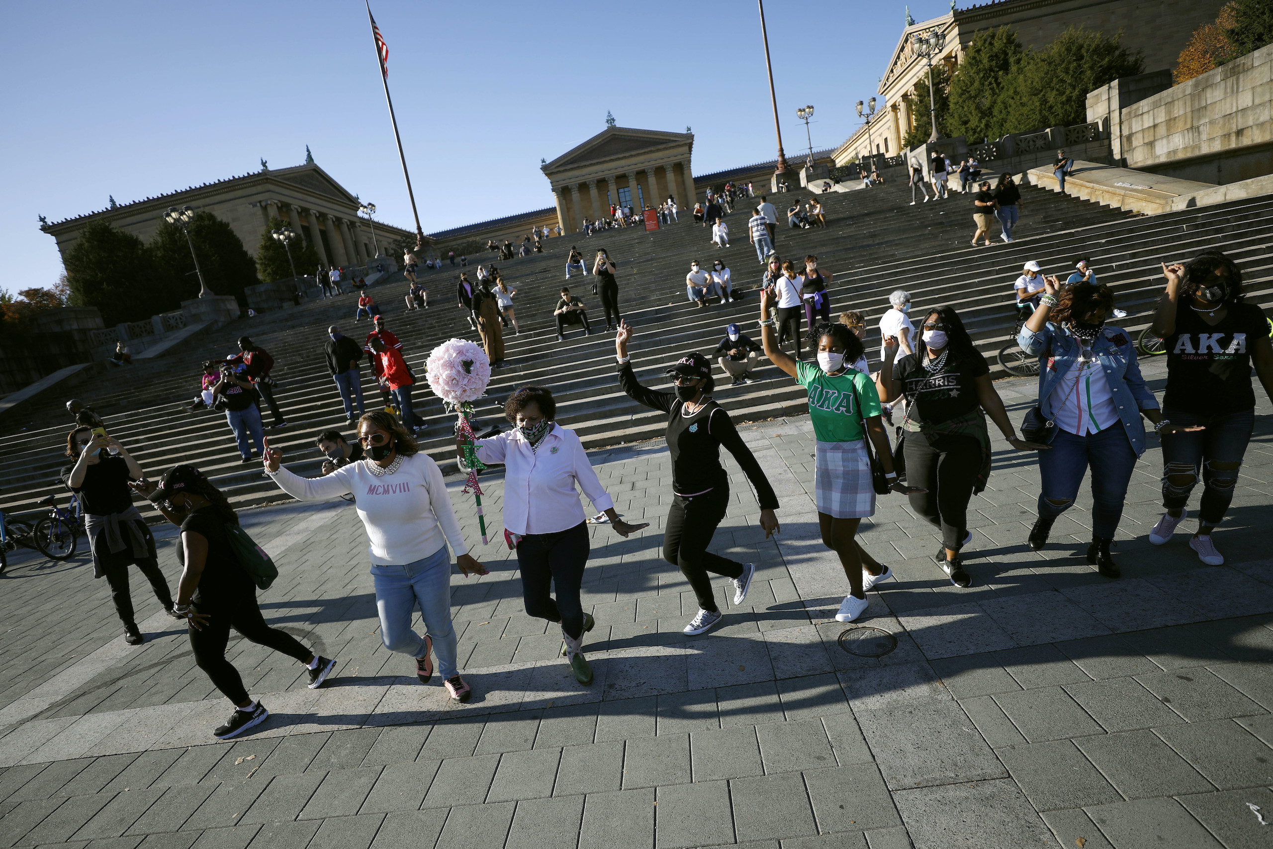 Members of various ages and different chapters of Alpha Kappa Alpha, the nation's first black sorority of which Vice President-elect Kamala Harris is a member, celebrate the election of President-elect Joe Biden and Harris outside the Philadelphia Museum of Art