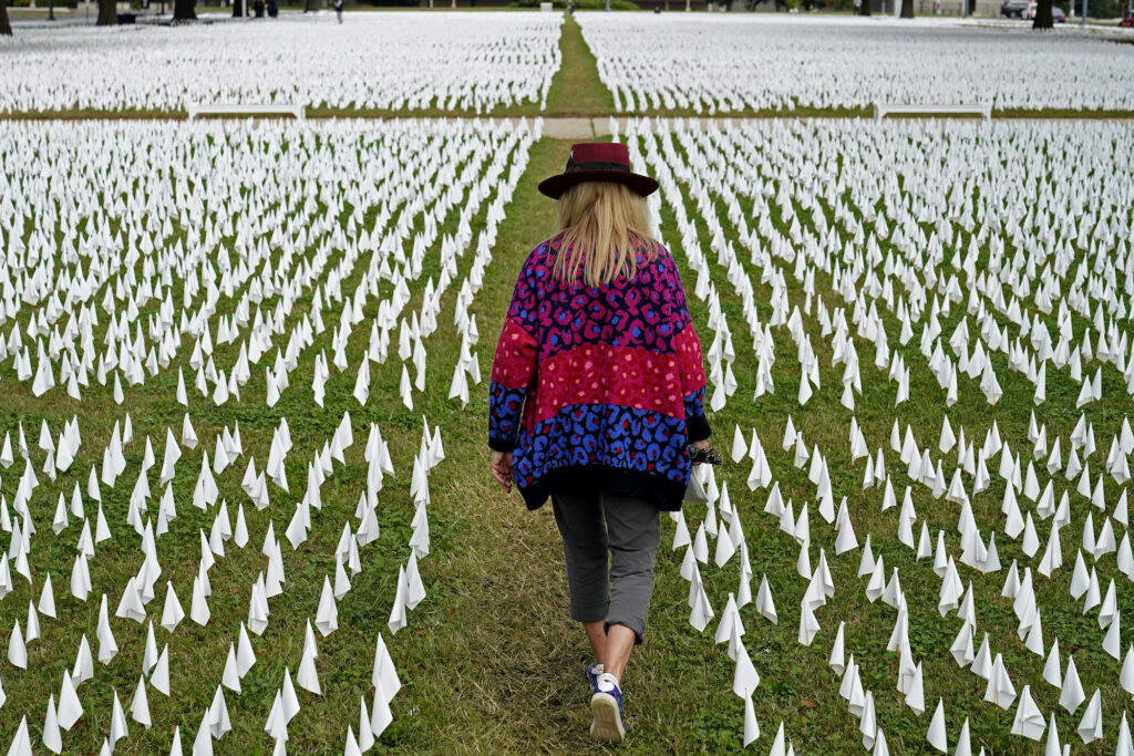 Suzanne Brennan Firstenberg Artist Suzanne Brennan Firstenberg walks among thousands of white flags planted in remembrance of Americans who have died of COVID-19