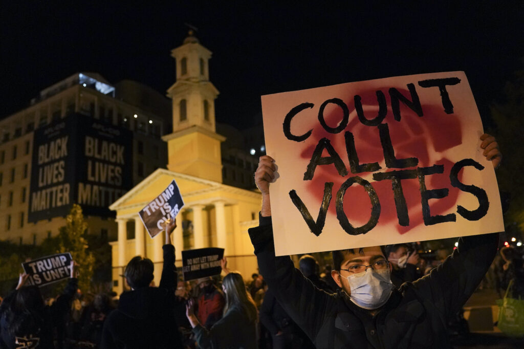 APTOPIX Election 2020 Protest Washington DC A demonstrator holds up a sign while waiting for election results