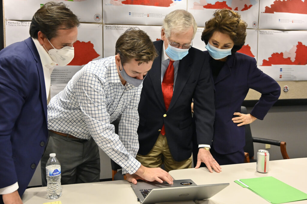 APTOPIX Election 2020 Senate McConnell Republican Senate candidate Sen. Mitch McConnell, center, and his wife, Secretary of Transportation Elaine Chao, right, look on as aides show him the election results