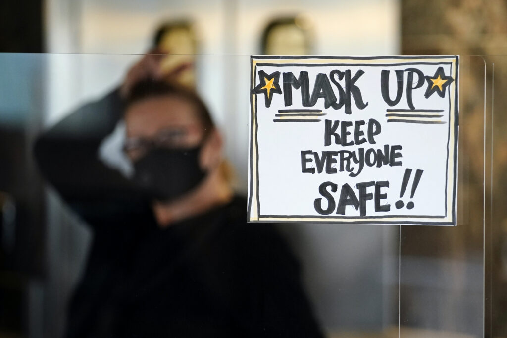 Virus Outbreak Pennsylvania A sign reminds patrons to mask up while inside a Pennsylvania restaurant.