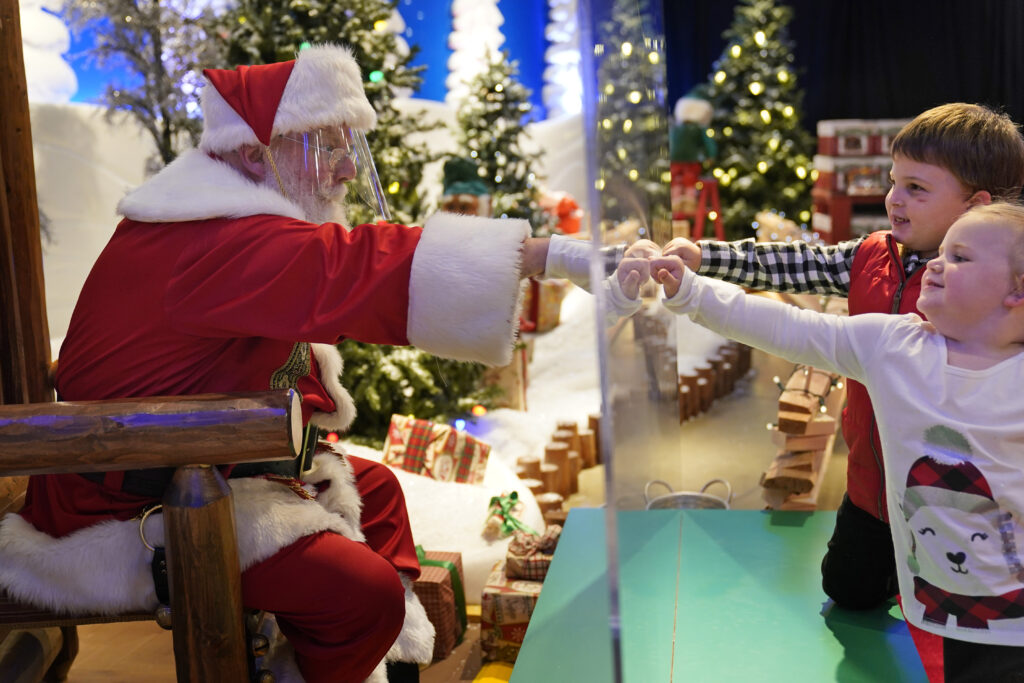 Julianna, 3, and Dylan, 5, Lasczak visit with Santa through a transparent barrier