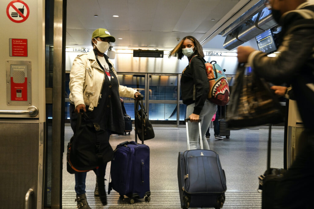 Travelers leave the AirTrain at JKF International Airport