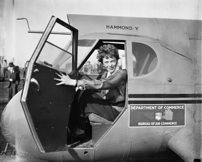 Amelia Earhart sitting in an airplane
