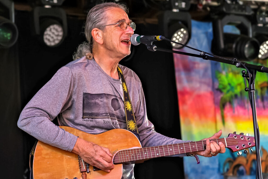 Musician David Gans playing guitar on stage