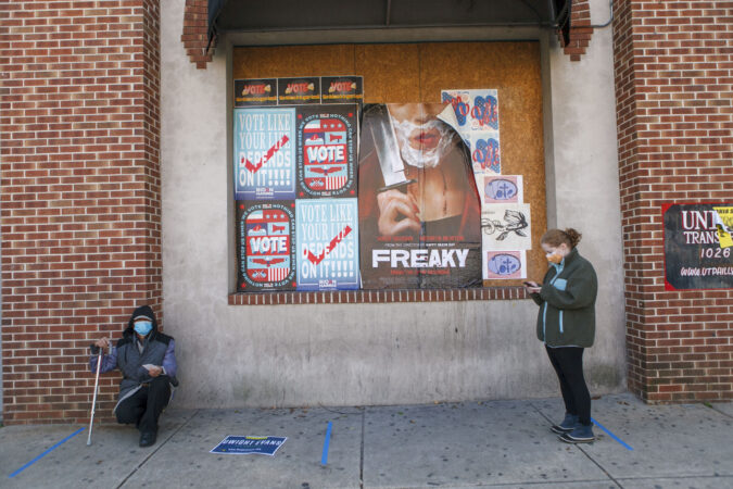 Voters practice social distance while lining up at polling place in Northern Liberties in Philadelphia on Election Day. (Miguel Martinez for WHYY)