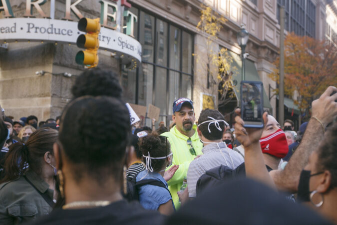 A Trump supporter clashes with Biden supporters during celebrations outside the Philadelphia Convention Center