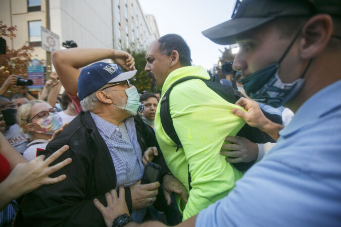A Trump supporter clashes with Biden supporters during celebrations outside the Philadelphia Convention Center
