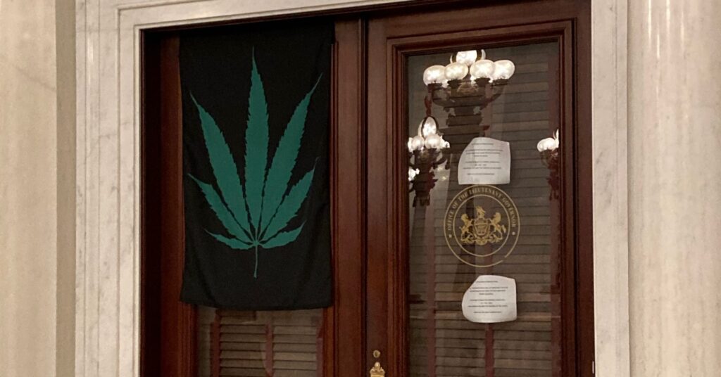 Fetterman-marijuana-flag-e1605910313146-1920×1005 A marijuana leaf flag hangs on the door of Lt. Gov. John Fetterman's office on Sept. 21, 2020. (Sam Dunklau / WITF)