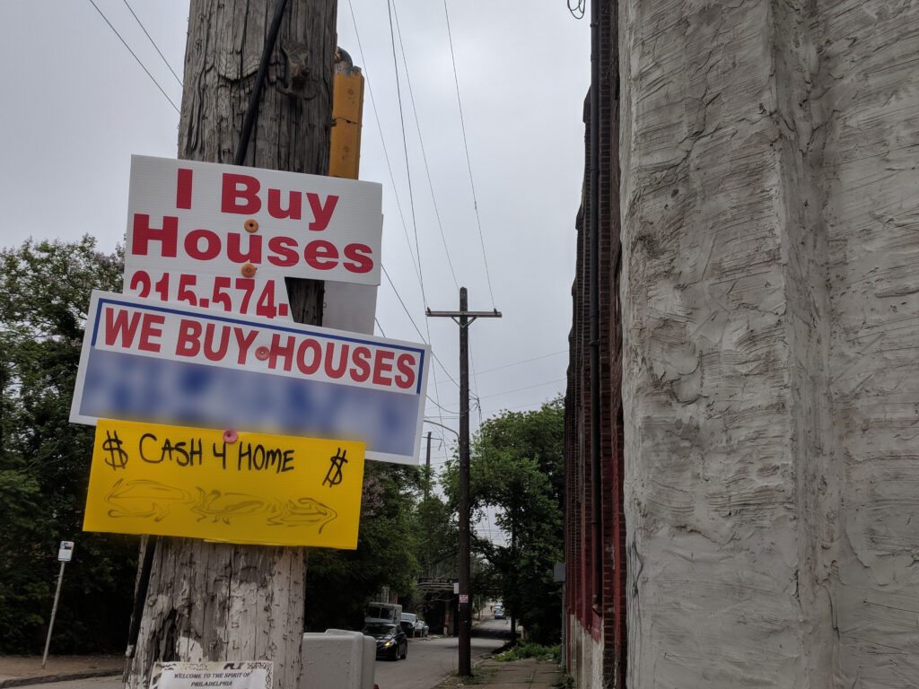 IMG_20180523_084203-2 Signs that read, ''I Buy Houses'' and ''We Buy Houses'' can be seen posted on a street pole in Philly