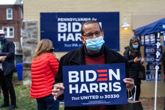 Neil Porter holds a Biden-Harris sign