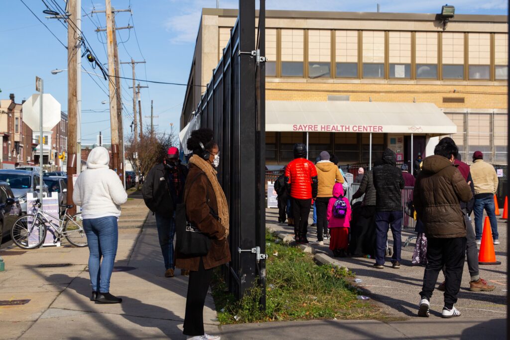 Image from iOS (251) People stand in line outside Sayre Health Center for COVID testing a week before Thanksgiving in West Philadelphia. (Kimberly Paynter/WHYY)