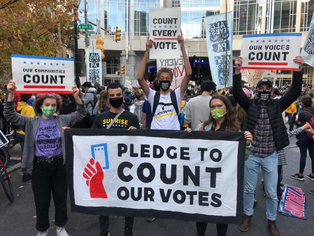 Image from iOS (6) Ed Brown (center in group photo), 17, stands with friends and Sunrise members at the Count Every Vote rally Thursday (Miles Bryan / WHYY)