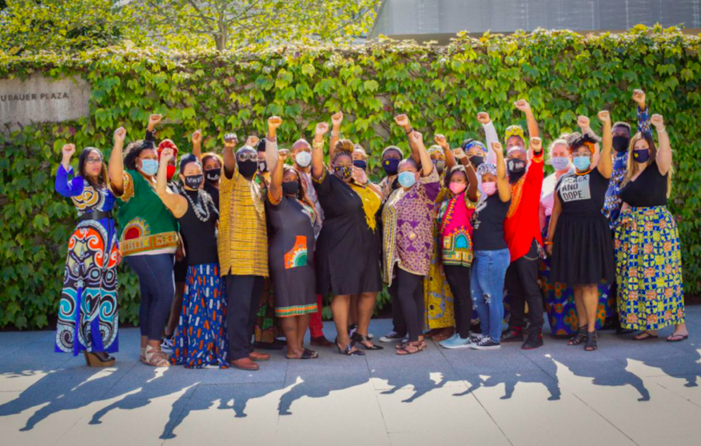 Screen Shot 2020-11-10 at 3.43.56 PM Mary McLeod Bethune Elementary principal Aliya Catanch-Bradley raises her fist with her staff during a recent birthday photoshoot at the Barnes Foundation. (Aliya Catanch-Bradley)