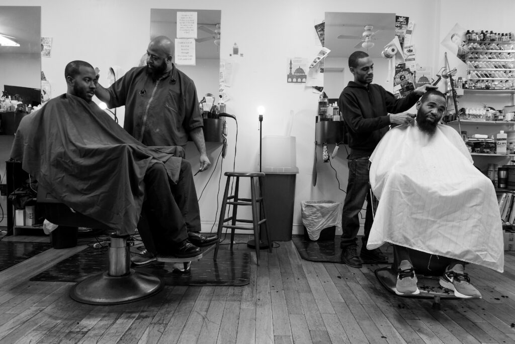You_Next_Final_Images_CRP_0122 G and his colleague both cutting the hair of clients. (Photo by Antonio Johnson/Produced at Gamin’ Cutz in Philadelphia, PA. December 2019.)