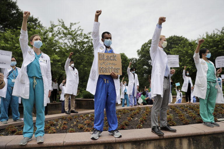 Healthcare professionals gather outside Barnes-Jewish Hospital in St. Louis to demonstrate in support of the Black Lives Matter movement on June 5. The demonstration, called 'White Coats for Black Lives,' was organized to show solidarity with those protesting the death of George Floyd after being restrained by Minneapolis police officers on May 25.
(Jeff Roberson/AP)