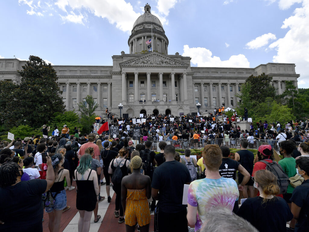 A crowd gathers for a rally to demand justice in the death of Breonna Taylor on the steps of the the Kentucky State Capitol in June. Taylor was killed in her apartment while Louisville police served a warrant. A crowd gathers for a rally to demand justice in the death of Breonna Taylor on the steps of the the Kentucky State Capitol in June. Taylor was killed in her apartment while Louisville police served a warrant. (Timothy D. Easley/AP Photo)