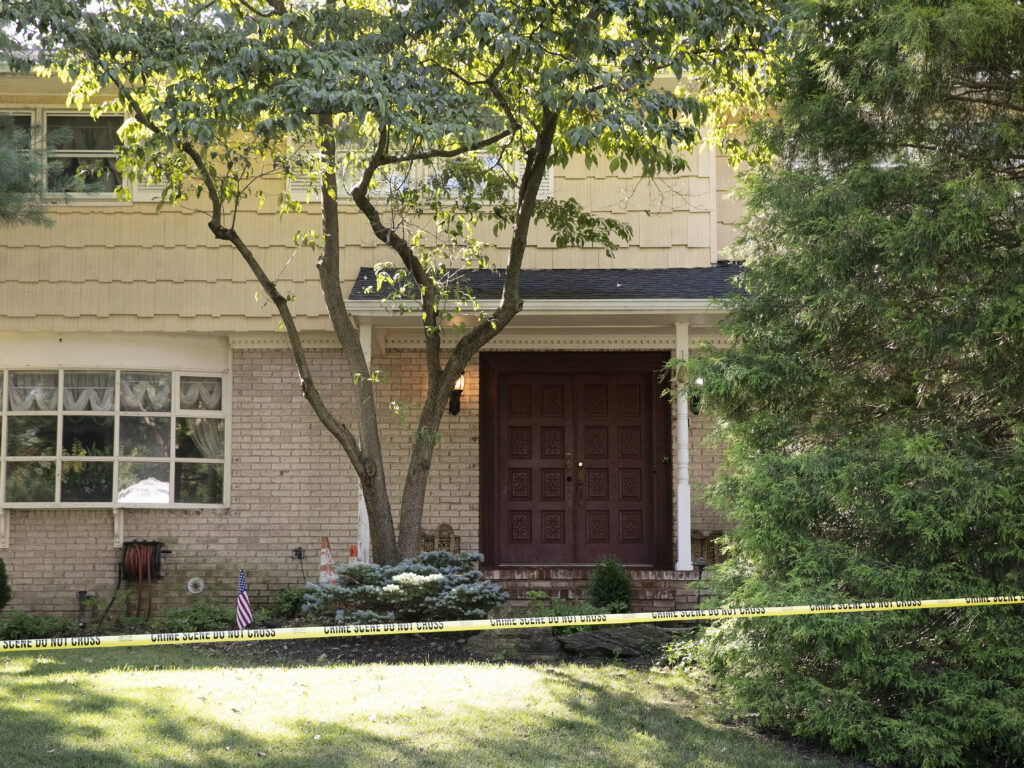 Crime-scene tape surrounds the home of federal Judge Esther Salas in North Brunswick, N.J., on July 20. A gunman shot and killed Salas' 20-year-old son and wounded her husband. (Mark Lennihan/AP Photo)
