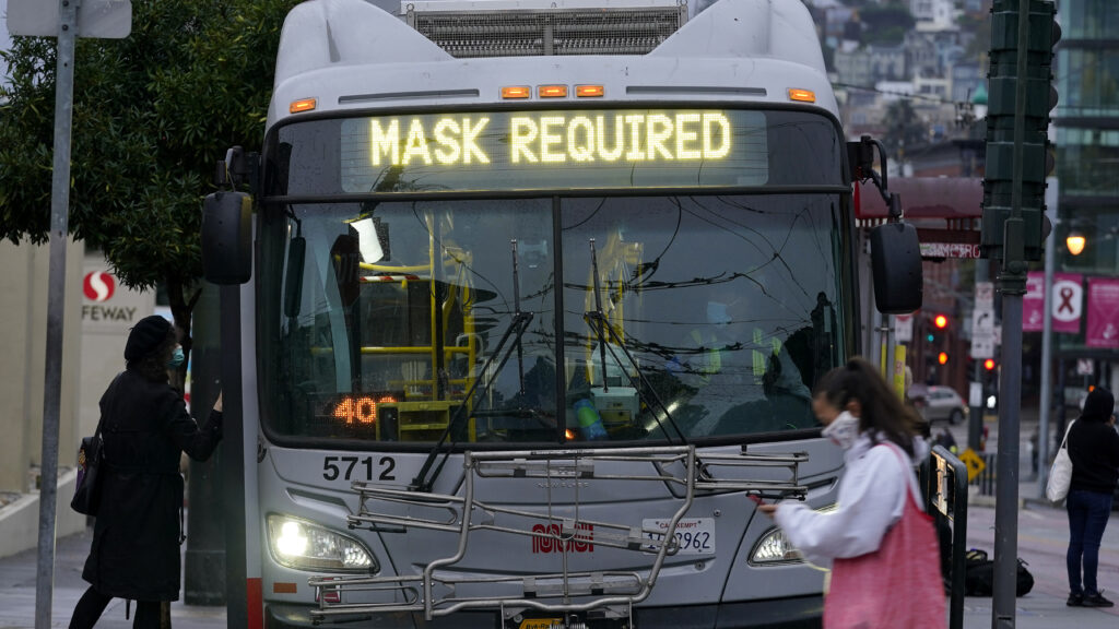 A sign on a San Francisco bus advises that passengers are required to wear masks. Health officials have renewed pleas for Americans to protect themselves and others from the coronavirus as the death toll passes 250,000. A sign on a bus advises that passengers are required to wear masks. (Jeff Chiu/AP)