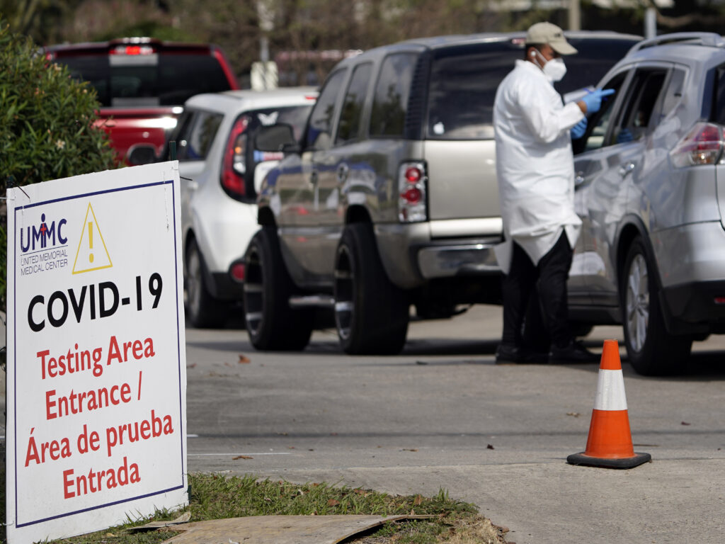 A healthcare worker processes people in line at a United Memorial Medical Center COVID-19 testing site on Nov. 19, in Houston. Texas is rushing thousands of additional medical staff to overworked hospitals as the number of hospitalized COVID-19 patients increases. A healthcare worker processes people in line at a United Memorial Medical Center COVID-19 testing site on Nov. 19, in Houston. Texas is rushing thousands of additional medical staff to overworked hospitals as the number of hospitalized COVID-19 patients increases. (David J. Phillip/AP)