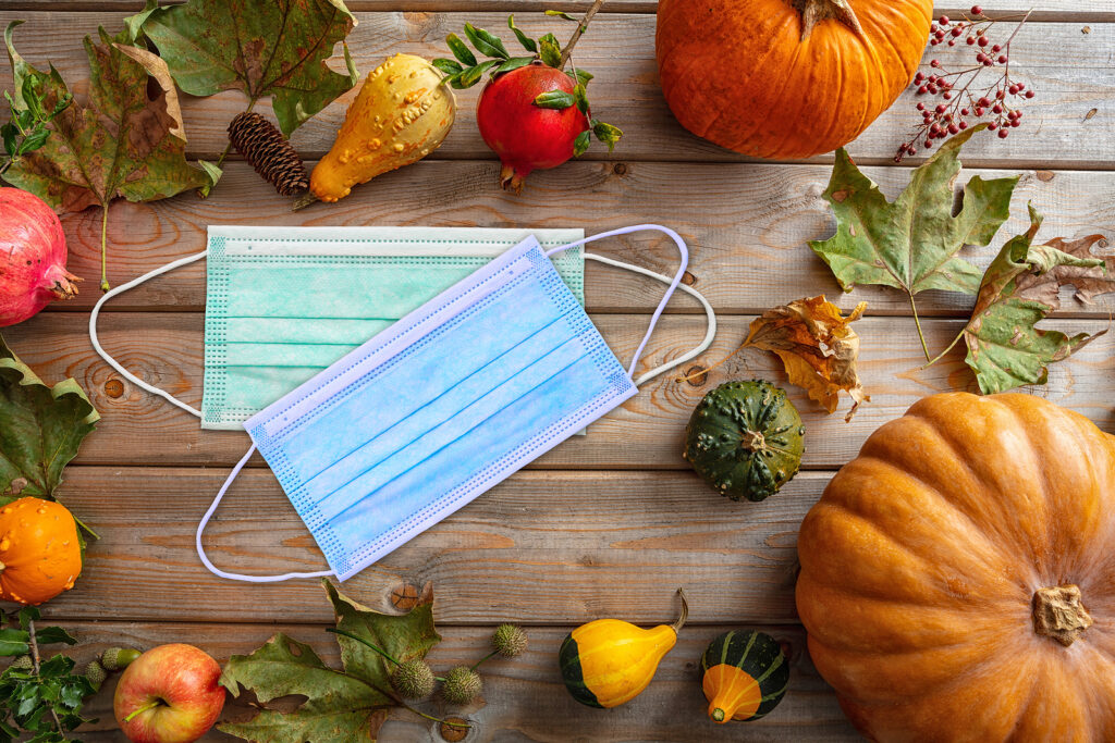 Protective Mask And Thanksgiving Pumpkins Against Wooden Backgro (Rawf8 / BigStock)