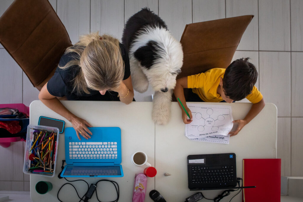 Working From Home And Learning Remotely As Cases Drop In Florida A mother works from home while her son attends school remotely