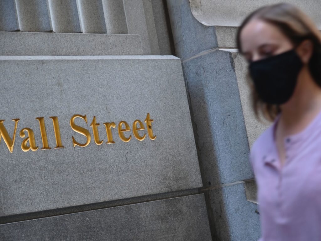 A woman walks by the New York Stock Exchange on Oct. 5. Stock markets are rallying at the prospect that this week’s elections will result in a divided government. A woman walks by the New York Stock Exchange on Oct. 5. Stock markets are rallying at the prospect that this week's elections will result in a divided government.