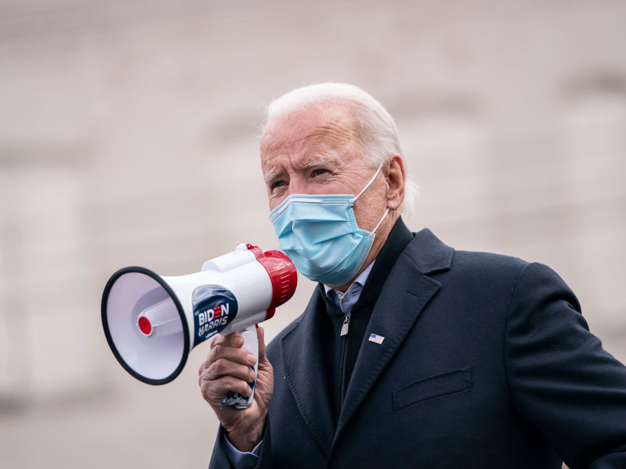 Even before becoming president-elect, Joe Biden has been working on a coordinated, national plan for fighting the coronavirus. Among other things, it will empower scientists at the Centers for Disease Control and Prevention to help set national, evidence-based guidance to stop outbreaks. Joe Biden speaks with a megaphone in hand while masked