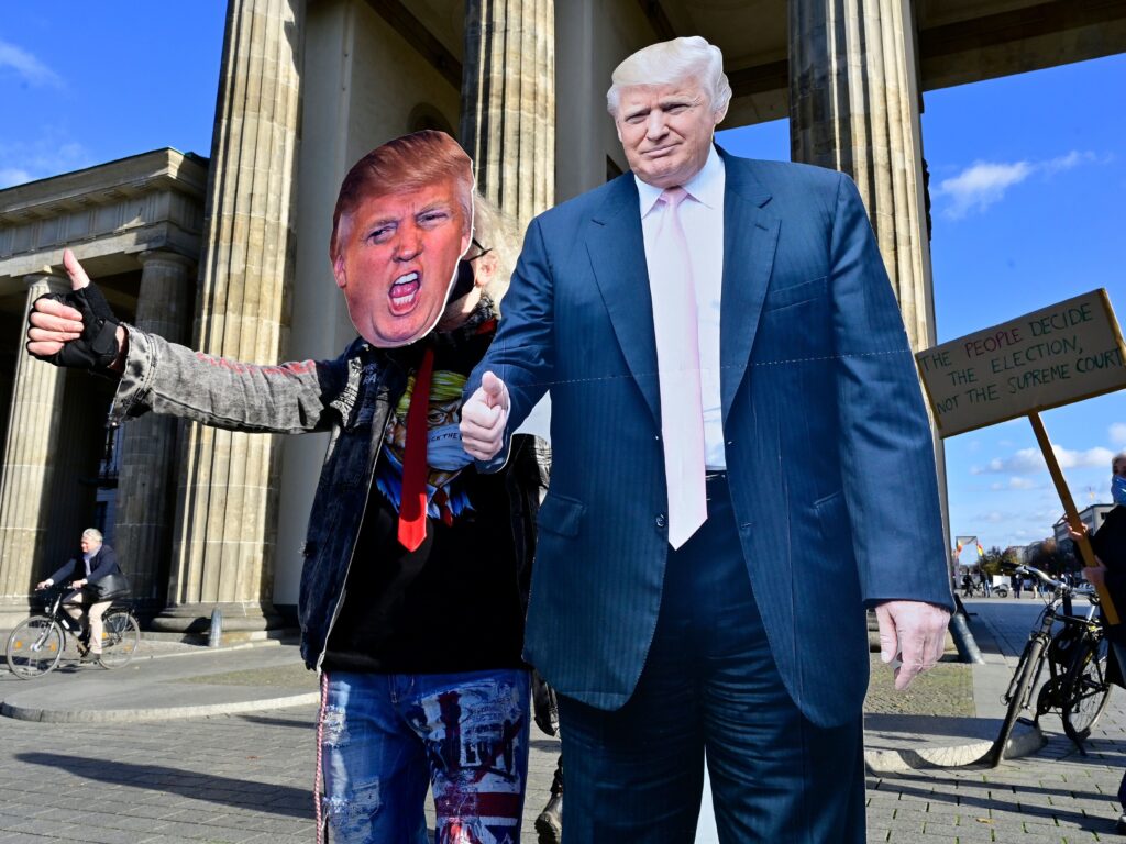 A supporter of President Trump’s poses with a cardboard cutout likeness Wednesday in front of the Brandenburg Gate in Berlin. A supporter of President Trump's poses with a cardboard cutout likeness Wednesday in front of the Brandenburg Gate in Berlin. (John MacDougall/AFP via Getty Images)